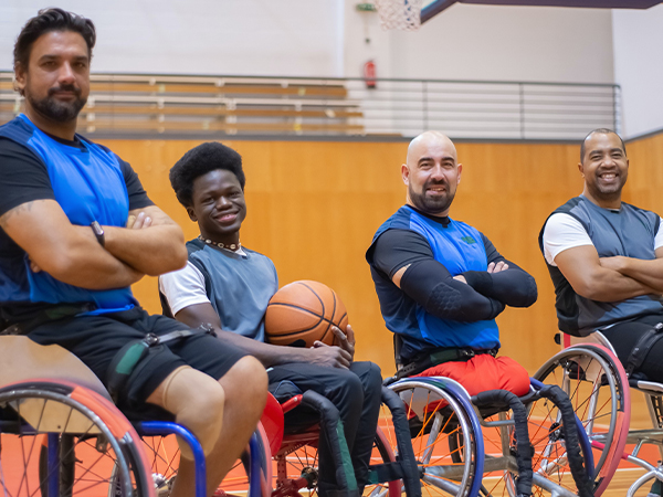 Group of men playing wheelchair basketball